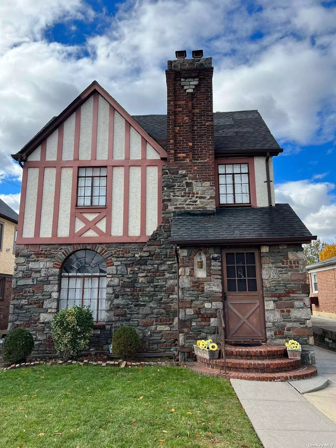 Detached stone and brick tudor on a quiet block in Bayside between Francis Lewis Blvd and the Clearview Expy. 2-car detached garage and long private driveway.