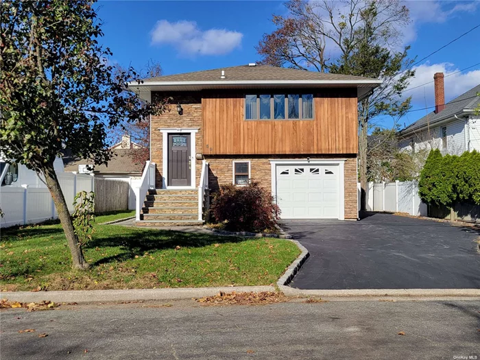 Welcome to this beautiful and spacious High Ranch with Southern exposure located in North Syosset. Walk to LIRR, shops, daycares, & houses of worship. Mint 4 bedrooms & 3 full baths with new bathrooms, kitchen, flooring, laundry room, as well as new stoop with vinyl handrails. Fully fenced-in backyard. Zoned to Village Elementary & Southwood MS.