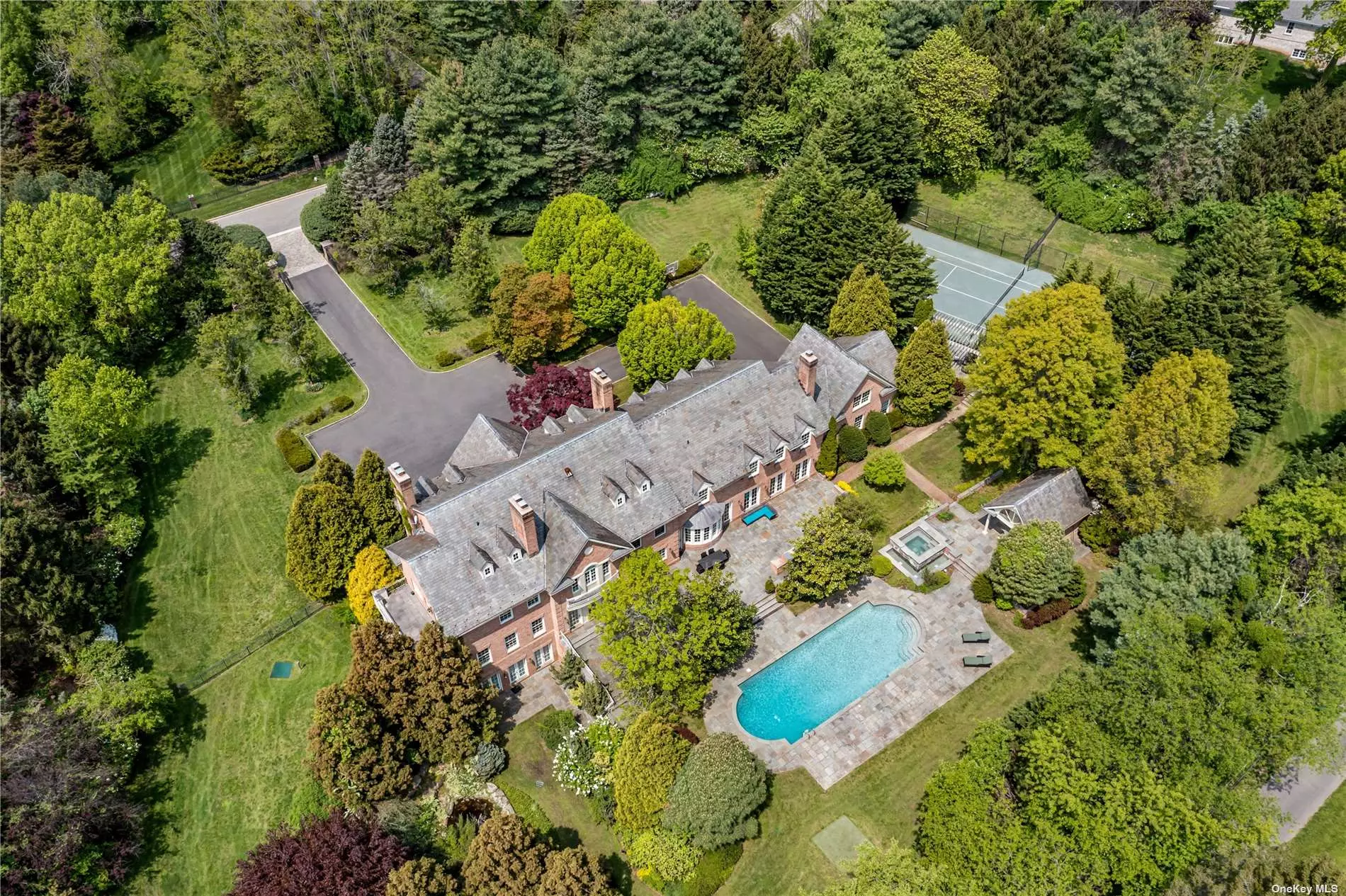 A 10, 000+ Sq.Ft. Brick Estate, located in the Heart of Old Westbury, NY. This magnificent, iron-gated 8 Bedroom, 13 Bathroom home sits tall on 5.25 rolling acres, with an in-ground pool, tennis court and putting green. Interior details include custom Millwork, oversized entertaining rooms, soaring ceilings, a 3-car attached garage and a spacious walk-out basement with a Media Room/ Theatre, Fitness Center, Billiards Room and Wine Cellar. Within the sought-after Jericho Union Free School District.