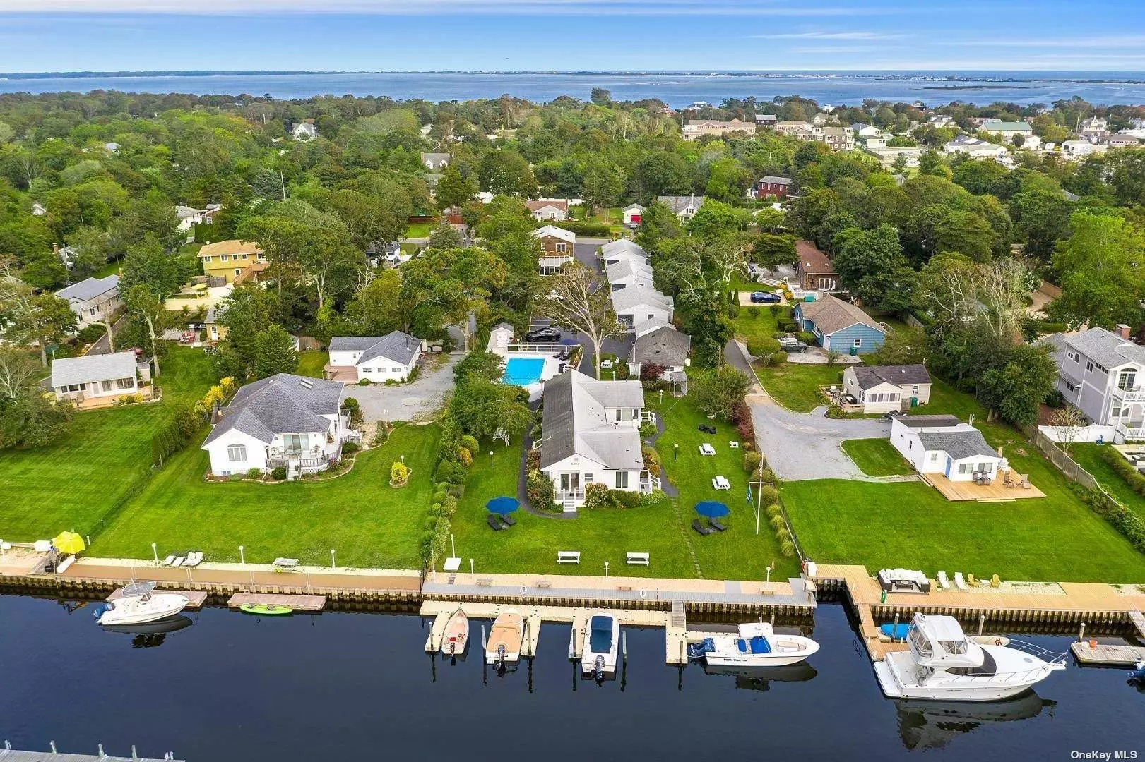 Presenting an exceptional opportunity to own an exclusive Hamptons waterfront resort. Unlike any other listing, this distinctive property offers fifteen contemporary renovated units, a main 3 bedroom residence with balcony, a waterside pool, 6 dock spaces for boating and water sports. This property is zoned as a resort waterfront business, providing investors and owners the power to fully pursue their creative vision, lifestyle and to be one of the select hotel owners in all of the Hamptons. With the potential for implementing a restaurant and entertainment environment, this space provides the flexibility needed to achieve your goals. Enjoy the unparalleled, panoramic water and sunset views of Shinnecock Bay. This one acre property is just minutes to Dune Road Ocean Beaches, waterfront dining and village shops.