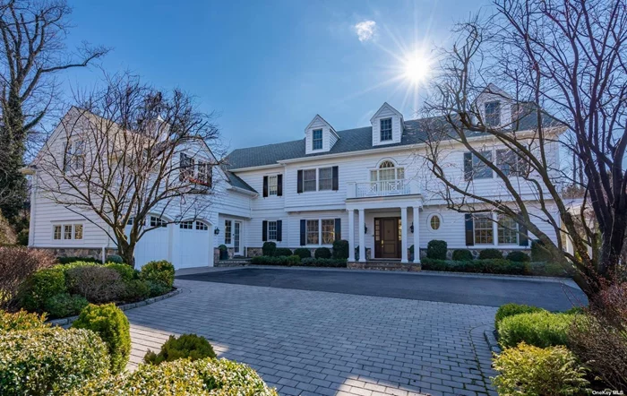 Exceptional five bedroom clapboard Colonial radiates graciousness, quality, warmth and style. Refined mill work, reclaimed wood floors, fireplace and oversized windows that feature captivating views of the Roslyn Estates pond distinguish the well-appointed interiors. Sophisticated in design, the study/home office is wrapped with richly paneled Pine-wood. For the chef, there are top of the line appliances. generous quartz prep island and sunlit breakfast nook. The kitchen seamlessly flows into the multi-windowed den where a stone fireplace is the focal point of the room. Enjoy entertaining on a grand scale in the formal living room and dining room. Classic in design, the luxurious primary suite features a Juliette balcony, fitted closets and marble bathroom. Transition into the chic lower level for your game day gatherings, movie madness and gym. Among the many amenities this meticulously maintained home has to offer, there is a bluestone patio, built-in grill and .82 acre of manicured lawn surrounded by mature plantings that add to the beauty and serenity of the property. Within minutes from the famed Americana shopping center, fine dining, golf, the beach and 35 minutes from NYC. Roslyn School District.