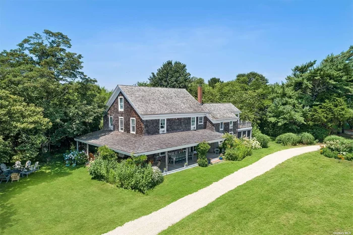 This bucolic property features a renovated two-story farmhouse c.1850 which is located near town/beaches and next to a 38 acre field. The house features a master suite with sauna, 3 additional bedrooms, 3 baths and a finished attic/bunk room. Outdoors, a whimsical treehouse, bocce court, a 20&rsquo; x 60&rsquo; pool, poolside pergola and beautiful apple, cherry and pear trees. There is also a large barn.