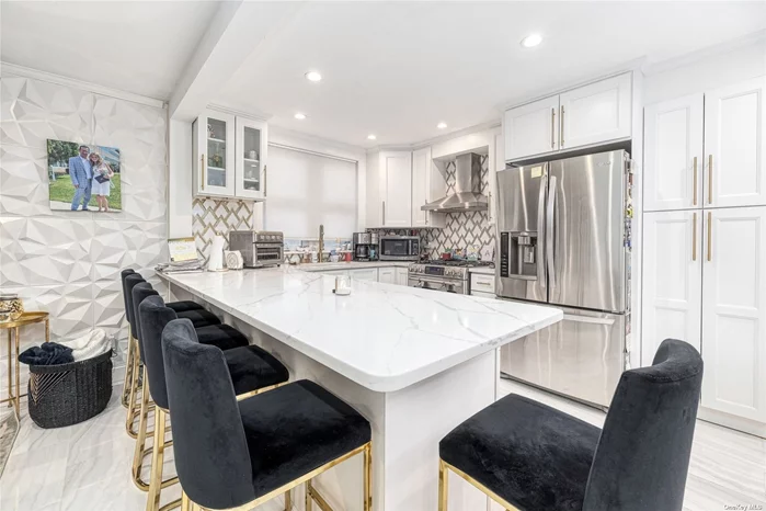 This beautiful fully renovated expanded cape is equipped with a new kitchen featuring Marble countertops, Stainless steel appliances, and white marble floors throughout the first floor. Whole house rental.