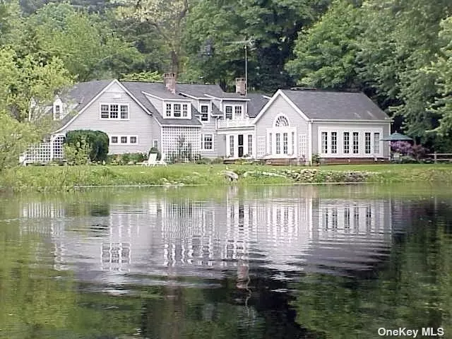 English Country Charm is felt the moment you enter this property thru the trellised, gated entrance leading to a stone walk way lined by lush perennial gardens with a fresh water pond sparkling before you. Close you eyes and relax to the sounds of nature with swans, ducks and other birds songs in this private woodland setting . The spacious farmhouse style home has window walls offering views of the pond and wildlife that delights the owners every day . The home has been carefully renovated to offer all of today&rsquo;s amenities while maintaining the charm that is hard to replicate in todays construction. A ground floor bedroom with plumbing for a bath is currently used for a home office with 4 bedrooms on the second floor including a large and bright Primary suite with full bath.This is a unique and hard to find setting that gives one the waterfront views of the pond and privacy while having easy access to public transportation, schools, shopping, dining and nearby golf and tennis clubs. A true Gem!!!