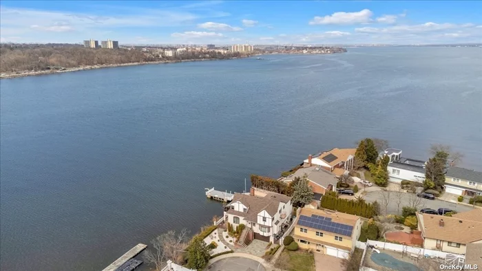 This magnificent waterfront home in Douglaston Queens boasts breathtaking views of Little Neck Bay and stunning western sunsets. It is located on a cul-de-sac in a quiet and serene neighborhood. It offers the perfect balance of luxury, tranquility, and natural beauty. This home presents a peaceful, private, suburban feel, yet it is less than half a mile to the LIRR station with a short 27-minute ride to Midtown Manhattan. It truly delivers the best of both worlds.  Upon entering the home, you are greeted by a flood of natural light that produces beautiful, sun-drenched rooms. The living areas feature large windows that deliver unequaled, unobstructed views of the bay while also seamlessly blending the indoors and outdoors. They allow the abundant afternoon sun to stream in and also deliver breathtaking sunsets over the bay in the evenings.  The home&rsquo;s six bedrooms offer ample space for rest and relaxation, with many rooms offering stunning views. The ground level offers walk out access to the inground pool which is surrounded by new pavers and a private dock. This level also includes an extra two-room suite with ensuite bath. This waterfront home in Douglaston Queens is truly a one-of-a-kind oasis that offers luxurious living and unparalleled views.