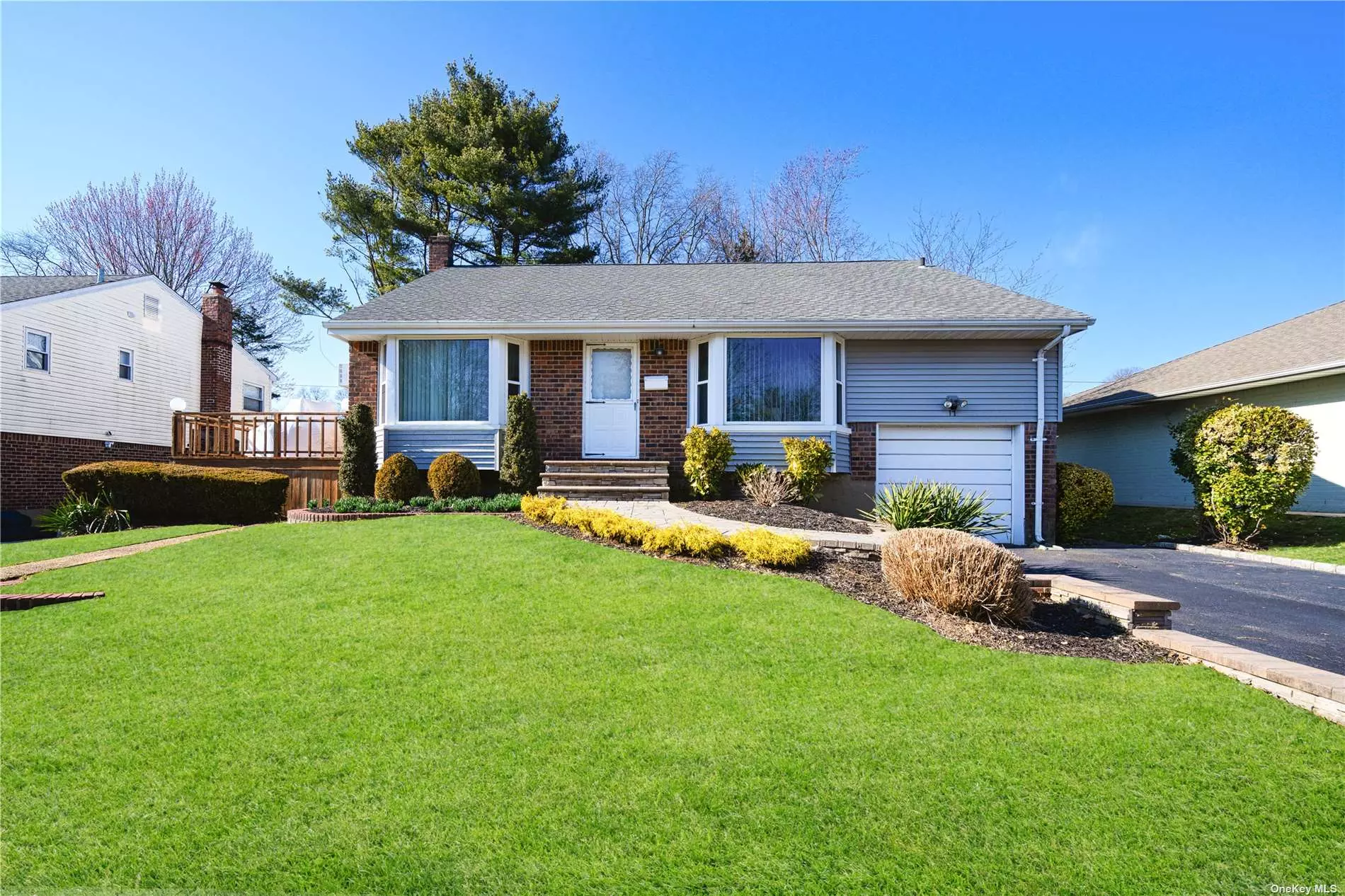 Open and airy front to back split, featuring 4 bedrooms, 2 1/2 baths, vaulted ceilings, large family room, great entertaining rooms and a private flat backyard. Wood floors under the carpet!!  quiet mid block location in Birchwood Syosset. located in Syosset schools, Robbins Lane Elementary. this is a must see family home!!