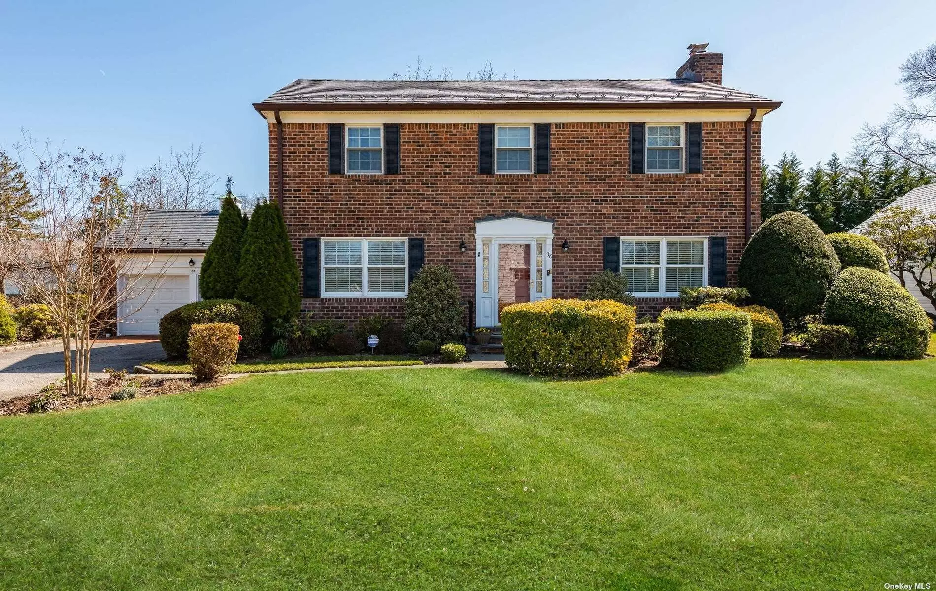 This classic brick Colonial is tucked away on a quiet street in Munsey Park. Upon entering the foyer, this charming home offers a living room with fireplace, formal dining room and a spacious eat-in kitchen. In addition, there is a den and powder room, along with access to a slate patio set in a private and serene backyard. Upstairs, there is a primary suite, along with two bedrooms and hall bath. Hardwood floors, full basement, 2-car garage, full house generator, slate roof, gas heat and heat pump, CAC, walk-in closets, and sprinkler system are some more features of this fine home.