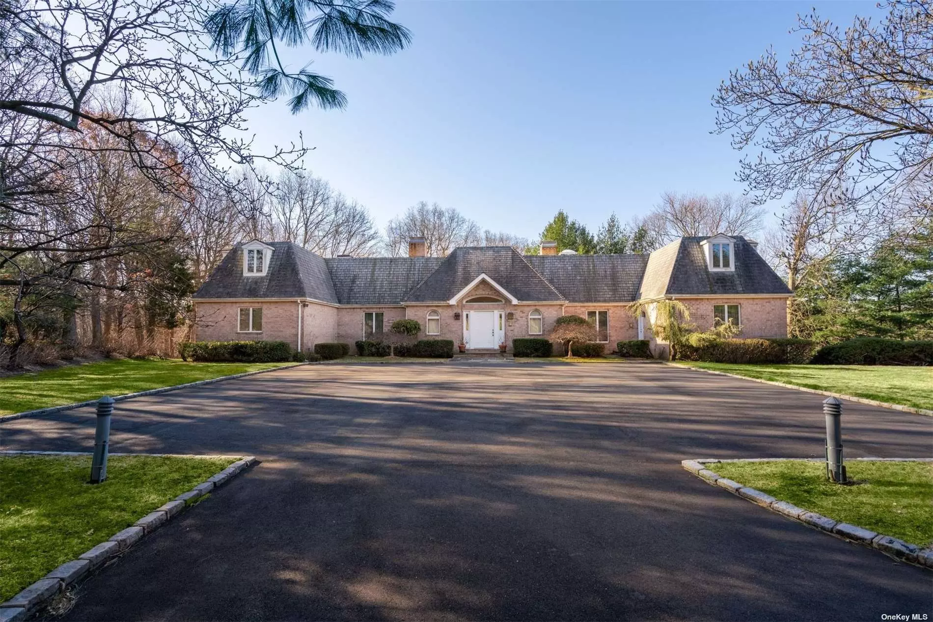 Normandy Manor A 6000sq.ft.French Normandy brick residence with East and West wings is approached by a long driveway and a large courtyard. It is situated on 2 professionally landscaped acres in the heart of Oyster Bay Cove .It is custom built with high ceilings, hardwood floors throughout and 3 fireplaces. Natural gas exists for heating and cooking on the brand new Viking stove. A Finished lower level with fireplace and glass doors that lead out to a patio creates even more living and entertaining space. Syosset schools, village police and beach and mooring rights complete the package.