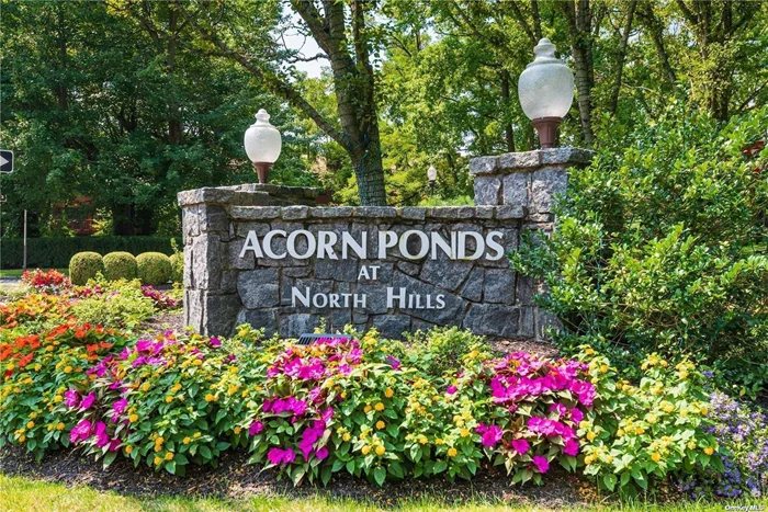 Fabulous opportunity to own a private end unit Cedar model which is the largest 2 BR model in Acorn Ponds. This highly sought-after beautiful home has 1885 sq ft and boasts 2 bedrooms and 2.5 baths. 1st floor includes a renovated eat-in-kitchen, a stacked washer/dryer, spacious sun drenched LR/DR combination,  polished hardwood floors and a powder room. 2nd floor includes a primary en-suite, an additional bedroom and full bathroom. There is plenty of closet space in both bedrooms including many built-ins. This unit sits on top of a hill and gets lots of natural air and light. Relax and enjoy the beautiful landscape from your private deck. A large 2 car garage with extra storage completes this lovely home. Country Club lifestyle includes indoor/outdoor pools, clubhouse, gym, park and tennis courts. Free Shuttle to Manhasset train station. Herricks Schools. Welcome Home!