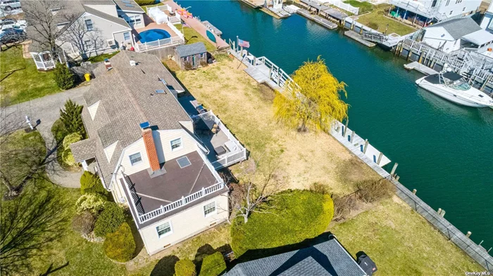 CALLING ALL BOATERS!!! Your Waterfront Dream Home Is Here!!! Updated Colonial On a Wide/Deep Canal W/ 100&rsquo; Ft Of Brand New Navy Bulkhead W/ 4 Floating Docks & Plenty Of Room For Your Boat & Jet Skis, Just Moments To Open Bay, W/ Large & Private Backyard/Outdoor Space Perfect For Relaxing & Entertaining, Entry Foyer, 1 Car Garage & Paved Driveway & Walkways, Oversized Living Room/Dining Room W/ Lots of Natural Sun Light W/French Doors Open To a Beautiful & Spacious TREX Deck W/a Stunning Water View, Beautiful Mahogany Hardwood Floors, Large Family Room W/Vaulted Ceiling and Skylight, Double-Sided Custom Built Stone Fireplace Open To Family Room & Dining Room Creating A Warming Ambiance,  Eik W/ New Stainless Steel Appliances & Granite Counter Tops & Custom Wood Cabinetry, 1st Floor Office or Possible 4th Bedroom, CAC, A Great Entertaining Room/Bar W/Skylight & French Doors Open to a Trex Patio, Spacious Master Bedroom W/Walking Closet & Water View, Updated Bathrooms, Brand New Washer & Dryer, New Recessed Lighting Throughout, Great Restaurants, Parks, Close to Bay Beach, shopping, Exclusive Rights to a Private Beach, Massapequa Schools, Elevation Certificate, LOW TAXES & Flood Insurance only $1, 200 Per Year - A Vacation Every day!!! Truly A Boat Lovers Delight, A Move-In Ready Home. A Must See!!!