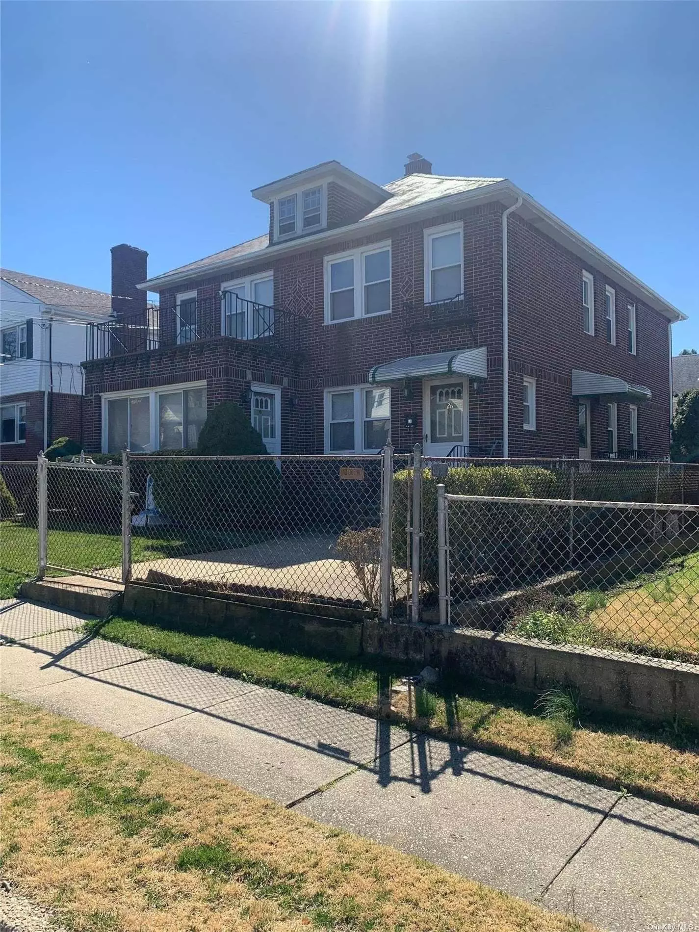 Stunning brick, legal two family home in the heart of Glen Cove&rsquo;s sought-after St. Rocco&rsquo;s section. This home features two identical units. First unit is ground level with a sunroom, full basement with separate entrance, and half a bath. Second unit is on the upper level with a walk out balcony. Each unit has the same footprint, EIK, LR, full DR, 2 bedrooms, bath, and laundry room. Beautiful preserved hardwood floors under carpet, separate gas and electric meters. Huge two car detached garage with spacious driveway. Maintenance free slate roof. Beach rights.