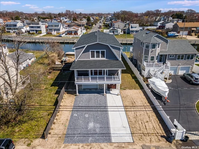 This waterfront boater&rsquo;s paradise in South Lindenhurst offers a spectacular view of sunrises and sunsets. This home checks every box with five bedrooms, four bathrooms, and three balconies. Our tour will begin on the top floor with crystal clear views of the spectacular waterfront; your elevator opens to your grand chef&rsquo;s kitchen with a 6ft Oyster Shell quartz island and pearl white cabinetry. Brand-new stainless steel appliances, including a GE stove with Wi-Fi, a walk-in pantry, two LG refrigerators, and a KitchenAid wine cooler. All windows are top-of-the-line high-end Euro-style. Full guest bathroom on the third floor with stunning fixtures, a primary bedroom with a water view, and a euro ensuite full bathroom with a 6&rsquo; tub and smart medicine cabinet. You can reach the second floor by elevator or stairway with four large bedrooms; one bedroom faces the front of the home with sliding glass doors to its private balcony and a full bathroom. Additionally, there is a laundry room and utility room. The first-floor entranceway features a Canadian-made front door with an interior doorway to your two-car garage and a large open area that can be utilized as an entertainment platform for billiards, a bar area, or a theater experience. Exterior features include vinyl siding, CAC, forced air heating, Rinnai tankless water heaters, and central vacuum. The 2-car driveway is found in front of the house. Located at the back of the home is a newly constructed bulkhead that allows you to enjoy the wide canal and by boat to Gilgo Beach, Captree Island, and Fire Island.