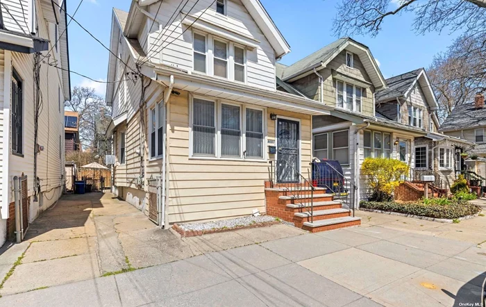 Located in the heart of Woodhaven, this colonial style home is just blocks away from the J subway and Q56 bus, making for an easy commute to Manhattan and other boroughs. Local shopping options include several supermarkets, specialty shops, and dining options .Full eat in kitchen with gas cooking, two pantry closets and entrance to the fully fenced backyard. Long driveway for off street parking. Original hardwood floors, moldings, and high ceilings give this home such character. Spacious living room and the formal dining room are perfect for hosting dinner parties. Upstairs, there are four spacious bedrooms with plenty of natural light and closet space. The basement has extra storage, full bathroom and an outside entrance. The gas boiler and hot-water heater were recently updated with 2 heating zones.