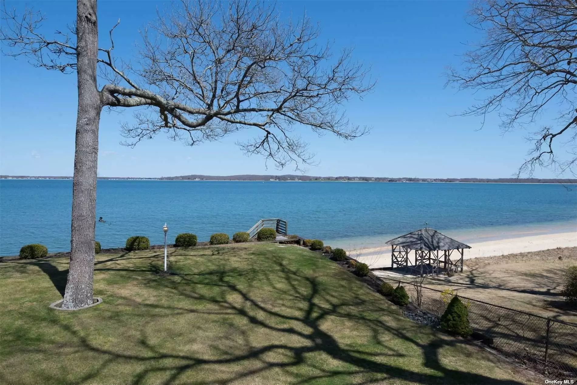 Rare opportunity to own a perfect North Fork bay front home in the highly sought after Reydon Shores community featuring your own private sandy beach. This amazing move in condition home offers breathtaking panoramic views of Shelter Island with 3 levels, 2 wood burning fireplaces, a great room, sunroom, loft , 6 bedrooms,  3 1/2 baths and a huge Trex deck for entertaining. In addition there is a separate 2 story/2 car garage with water and electric, manicured landscaping, Slate Roof and CAC. The lower level of the home is on grade level leading directly to the back yard offering a waterfront office,  entertainment room with fireplace, laundry room and separate storage rooms. Property is located outside of the Flood Zone. Association dues $350/year, Marina fee is $20/foot.