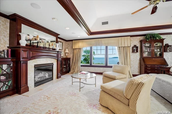 Primary bedroom w/fireplace and direct water views