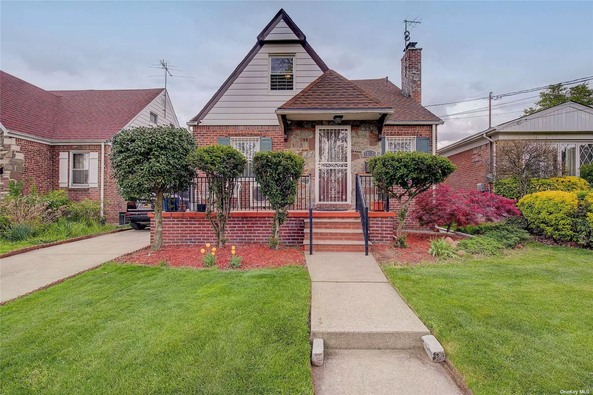 Welcome to this beautiful brick Tudor style cape with a mother/daughter style layout with two gas and electric meters. Deceivingly large, boasting over 2000 square feet of interior living space with second floor dormers that transcend the second floor. Located in a highly desirable area, Prime Bayside in close proximity to both Bell Blvd and the Long Island Rail Road. The main floor features two large bedrooms, perfect for those who prefer single-level living or for use as a home office or guest room. The spacious living room contains a fireplace and flows seamlessly into a cozy dining area, creating an ideal space for family gatherings and entertaining.The updated kitchen boasts modern appliances, plenty of Granite counter space, and ample storage, making it the perfect spot to prepare your favorite meals.The second floor of this home features three additional bedrooms, and an extra living area providing plenty of space for a growing family or for use as additional office space. All of the bedrooms are bright and spacious, with beautiful hardwood floors and ample closet space. There is a full bathroom on each floor of this lovely home, offering convenience and ease of use for all residents.The basement is fully finished with a summer kitchen, bathroom and separate entrance. This home also features a new roof and also includes a detached garage and a long private driveway.