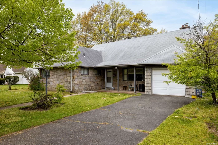 An expanded 6 Ranch 3 Full Bath with 2605 SQ Ft of living space on a 10, 000 SQ FT lot.Hardwood floors. Close to many homes of worship, shopping and Lirr.