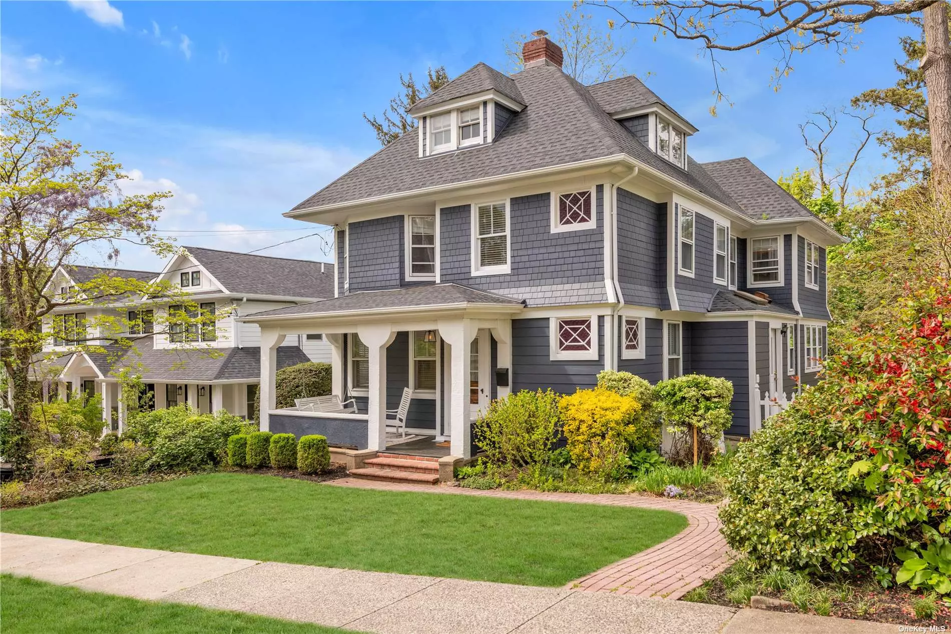 Nestled among the stunning streets of Port Washington, this lovingly restored and well maintained vintage front porch colonial on a spectacular double lot is a true gem from the turn of the century. Boasting 5 bedrooms, 2.5 baths and over 4, 000sf on all 4 levels, this custom residence exudes timeless elegance and exquisite architectural millwork, making it the perfect place to call home. On the first floor, enter through a graceful foyer and step into a spacious living room with wood burning fireplace, formal banquet sized dining room, bright den/office, English country kitchen with brand new Quartz countertops, stainless steel appliances, and a powder room. Three bedrooms and a full bath off a long hallway lead into the fourth, and beautifully kept, primary suite with updated primary bath, completing the 2nd floor. A bright and palatial 3rd floor walk-up contains the 5th bedroom, with plenty of storage. Sliding glass doors in the finished lower level open onto a bluestone patio and expansive double lot property. New roof and hardie board siding, detached two-car garage, hardwood floors throughout, 2 zone CAC, and laundry on first floor. Beach rights (with fee). Stroll to Inspiration Wharf, town dock, and wonderful restaurants and shops on charming Main Street. LIRR to Penn Station and Grand Central Station. Quality craftsmanship and warmth abound in this bright and sunny conveniently located home.