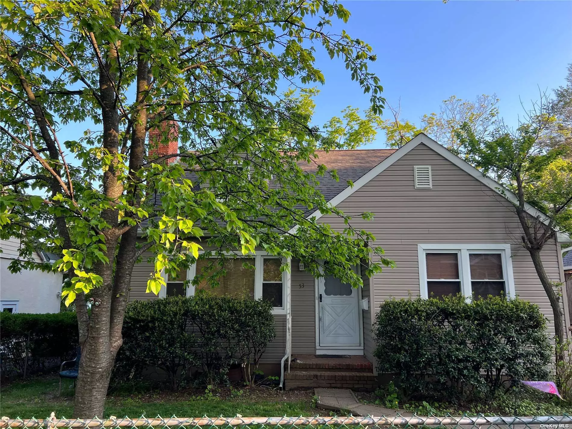 Very Spacious 4 Bedroom Cape on quiet tree-lined street. This lovely home features a huge Living Room/Dining Room combo, Eat-in-Kitchen, Bedroom, Powder Room and Laundry on the first floor. The second floor boasts 3 good-sized Bedrooms, a large cedar closet and knee wall attic for extra storage, & a Full Bath. Large Part Finished Basement with Separate Office Space, Sep Boiler Rm, Storage. New Siding, New Roof. North Shore Schools, beach privileges. Close to Railroad, shopping, dining.