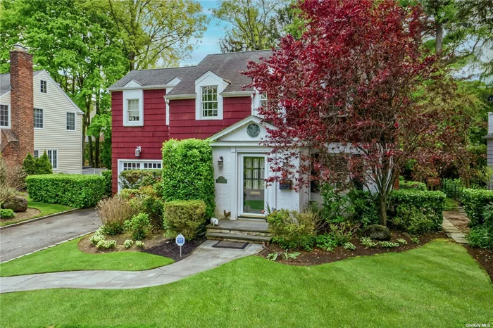 Classic 5-bedroom, 2.5-bath updated Colonial in Manhasset Bay Estates has it all. Living room with wood-burning fireplace opens to large great room and kitchen with wall of windows leading to 60 X 100 ft. property. Lovely, well done side entry has a mudroom and is accessed through the kitchen or the 1-car garage. Formal dining room and half bath complete the first floor. Upstairs there are 4 bedrooms plus the primary suite with 2 walk-in closets and large bath. Hardwood floors throughout, sprinkler system, alarm system, beach and mooring rights with fee, and so much more. This home is extremely well located with regard to town, train, and the Pine Street Park.