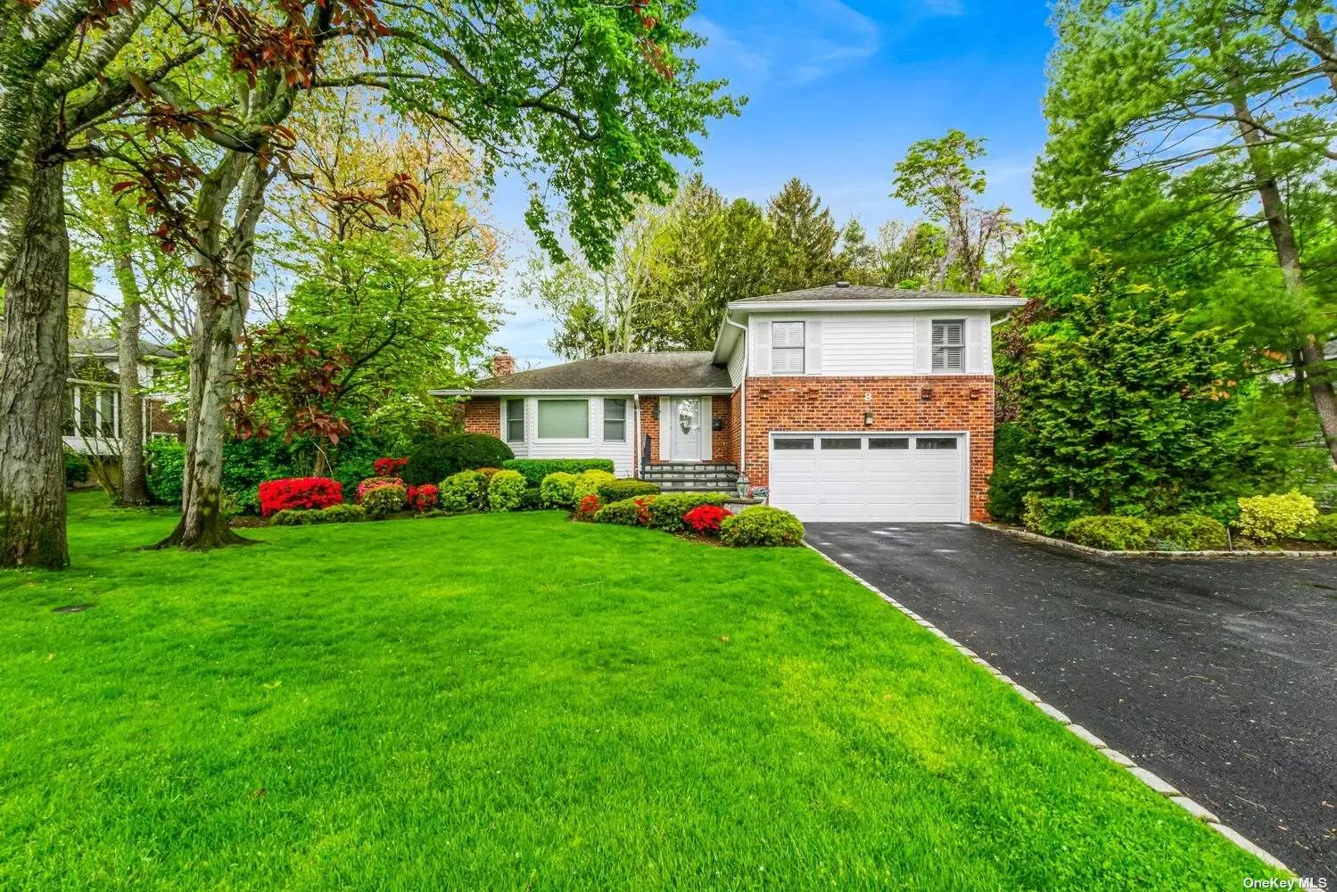 ELEGANT 3 BEDROOM 2.5 BATH BRICK SPLIT LEVEL HOME IN PRISTINE CONDITION SITUATED ON OVER 1/3 ACRE OF MANICURED PRISTINE PARK-LIKE PROPERTY IN THE DESIRABLE FLOWER HILL NEIGHBORHOOD. ENTRANCE FOYER LEADS YOU TO A DRAMATIC SUNKEN LIVING ROOM WITH GLEAMING HARDWOOD FLOORS & WINDOWS GALORE WHICH ALLOWS THE SUN TO STREAM THROUGH. RECENTLY RENOVATED CHEF&rsquo;S KITCHEN WITH TOP OF THE LINE CABINETRY AND STAINLESS APPLIANCES, GRANITE COUNTERS AND GAS COOKING WITH EXHAUST HOOD ALL OVERLOOKING A PICTURE PERFECT BACKYARD. RELAX AND UNWIND IN THE FAMILY ROOM WITH GAS FIREPLACE WITH DOORS TO THE PATIO.  FULL HOUSE GENERATOR & ALARM, GAS HEAT AND COOKING, CENTRAL AIR, IN-GROUND SPRINKLERS, CENTRAL VAC, CEDAR CLOSET, SURROUND SOUND SPEAKERS, ROSLYN SCHOOLS, PW TRAIN STICKER.