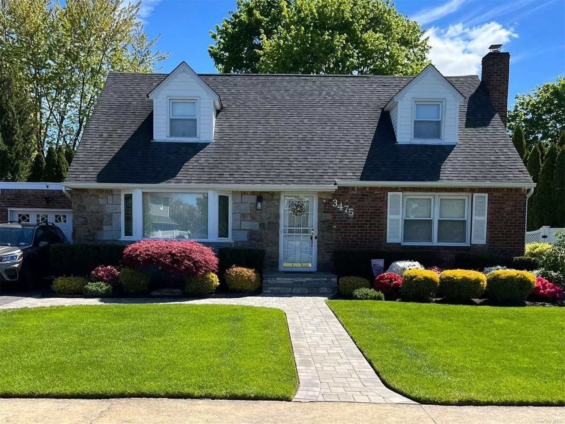 Welcome home to this spacious updated cape in the heart of Wantagh Woods. The beautifully manicured yard with inground sprinklers & deck make this a perfect spot to entertain. The updated kitchen features granite counter tops. The living room leads into the formal dining area. The den/family room with access to yard is the perfect spot to relax. King size primary bedroom plus 3 additional large bedrooms. Updated bathrooms include a jacuzzi tub. Full finished basement, hardwood floors, new boiler and hot water heater, new garage door, alarm system. Close to Train for easy commute to NYC. Located in the Wantagh school district 2 blocks from Wantagh elementary school. Low Taxes !!
