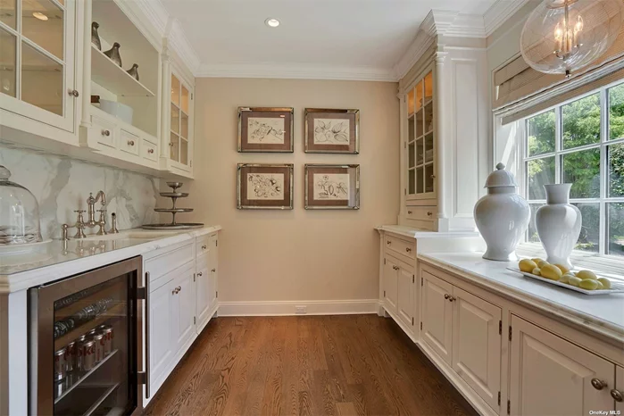 Butler’s pantry room includes marble countertops and SubZero beverage and ice maker