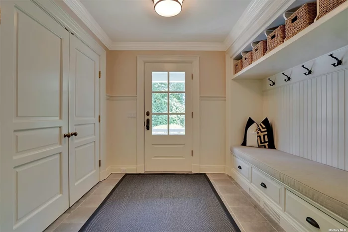 Spacious mud room w. built-in cabinetry and bead board accent moldings