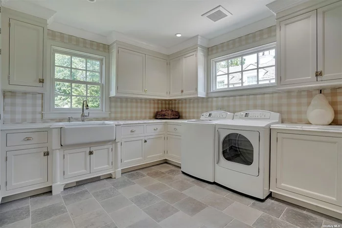 Laundry laundry room w. custom cabinetry, marble counter tops and electric built-in ironing board