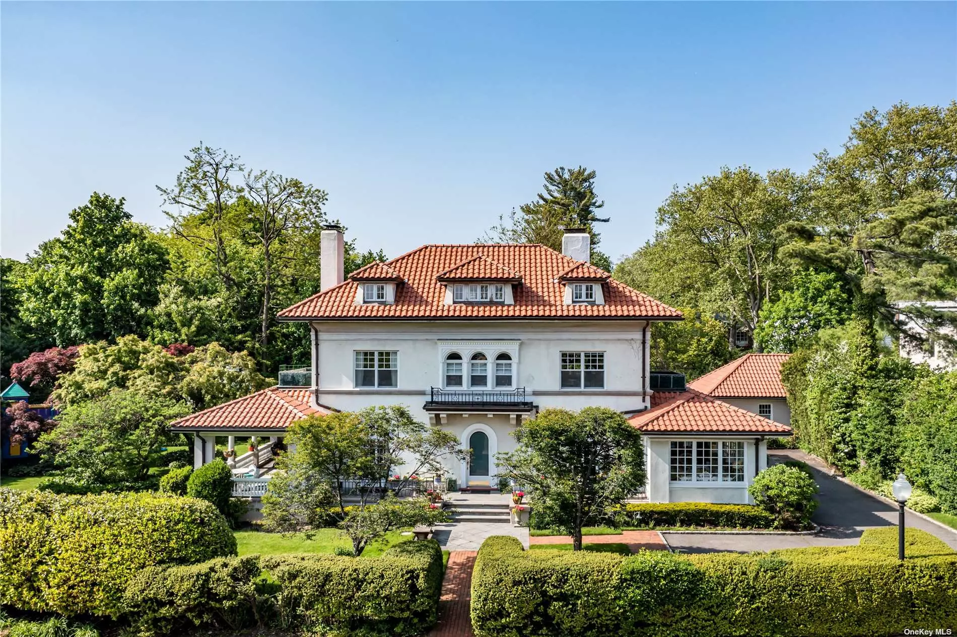 One of Kensington&rsquo;s most coveted historic homes, 1 Beverly Road, was built in 1908 and is a Mediterranean Masterpiece with beautiful 20th Century influences throughout the residence. This colorful, jovial home shows like a piece of art with gracious oversized French Doors, treasured crystal light fixtures, gorgeous hardwood floors, curved plaster crown moldings and 3 original Marble/Sandstone wood-burning fireplaces. Tastefully renovated, this 3-story 5, 000+/- Sq.Ft. home has 6 bedrooms and 4.5 bathrooms. Constructed with a solid Stucco facade and a bright Italian Terracotta roof, the home&rsquo;s exterior architectural elements are impeccable. Embrace outdoor living at the highest caliber with an opulent covered slate porch, a bespoke outdoor playhouse and a separate patio framed with boxwoods, great for grilling, hosting or sunbathing. Dubner designed landscaping with an irrigation system, decorative lighting and mature trees, including a 100-year old Hydrangea tree, outfit the property providing ample shade and privacy. Situated in the highly desirable Village of Kensington, facing the Village Green and Gazebo. On one of the largest lots in the neighborhood, spanning a total of .52 sprawling acres, with room and (pre-drawn up plans) for an in-ground pool.