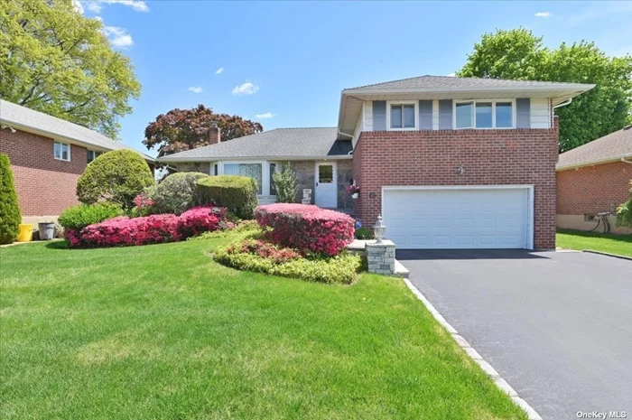 Syosset Clearview Village Development on Mid-Block Location 65x100 Flat Property! Brick and Fieldstone Exterior. Beautifully Designed Paving Stone Steps and Entry. Wide 2 Car Blacktopped Driveway and 2 Car Garage with Easy Entry Directly into Family Room. Spacious 3 Bedroom, 2.5 Bath Wide-Line Split. Entry Foyer Has High Ceilings. Bright Living Room with Anderson Windows Leads to L-Shaped Dining Room. Ready for Holiday Dinners! Kitchen has Ample Breakfast Space and Convenient Door to Deck! Upstairs to Primary Bedroom w/Updated Bath + 2 Additional BRs and Bath. Family Room includes 1/2 Bath that Can Expand to Full. Bonus 3 Season Room! All CO&rsquo;s in Place. Full Finished Basement with Amazing Storage, Laundry and Utilities. Gas Heating-3 Zone, 40 Gallon HWH, CAC, 150 Amp Electric Service, UGS. School District #2. Baylis Elem, Thompson Middle, Syosset High Taxes w/STAR $18, 151 Grievance filed for &rsquo;23 and &rsquo;24. Make This Your Own!