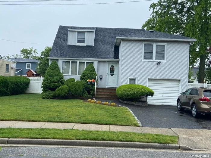 Welcomed to this well maintained Split south of Merrick Road .Needs some Tlc, Offers: Vinyl Siding , Updated Windows, Hardwood Floors under carpet, Heating System 2012,  Roof less then 10 Yrs Old, Low Taxes, Beautiful Yard with Patio and Awning. Close to Marina , School , shopping and Major Transportation. A must see!