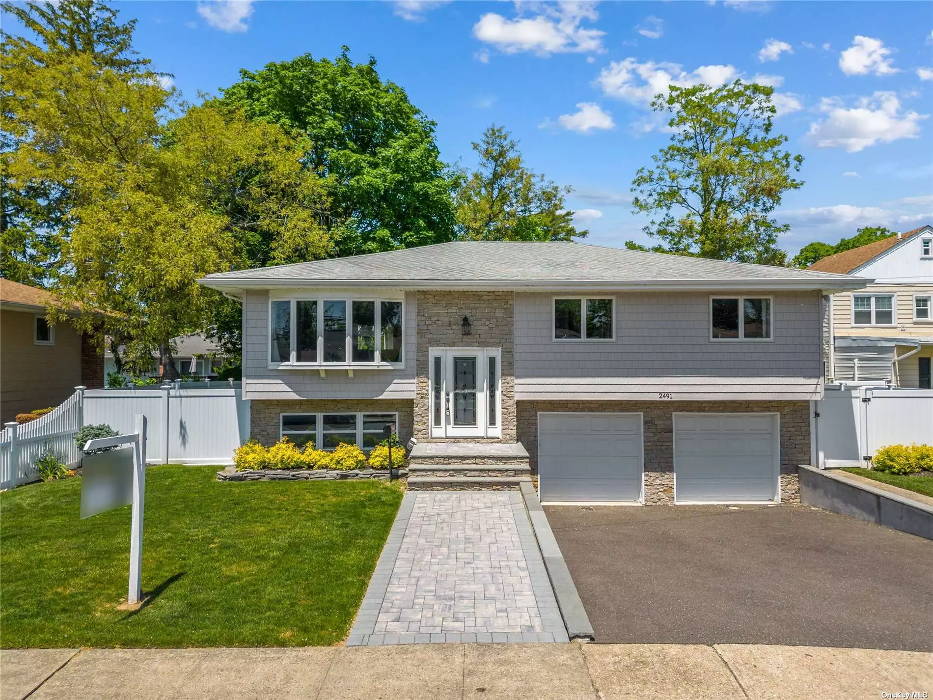 Nestled in Bellmore&rsquo;s coveted Old Britton Estates, this high-ranch gem is designed with entertainment in mind. Discover an expansive open-plan living area, including a chef&rsquo;s kitchen equipped with a 12-ft island, white cabinets, quartz countertops, and stainless-steel appliances. Adjacent is the formal dining room with backyard access. This home offers a luxurious master suite, three additional bedrooms, and two full baths. The lower level boasts a large family room, another full bath, and a combined laundry/utility room with direct access to a two-car garage. Notable features include a PVC fence, central air conditioning, hardwood floors, and a 5-zone in-ground sprinkler system. Experience the elegance and comfort of this distinguished property.