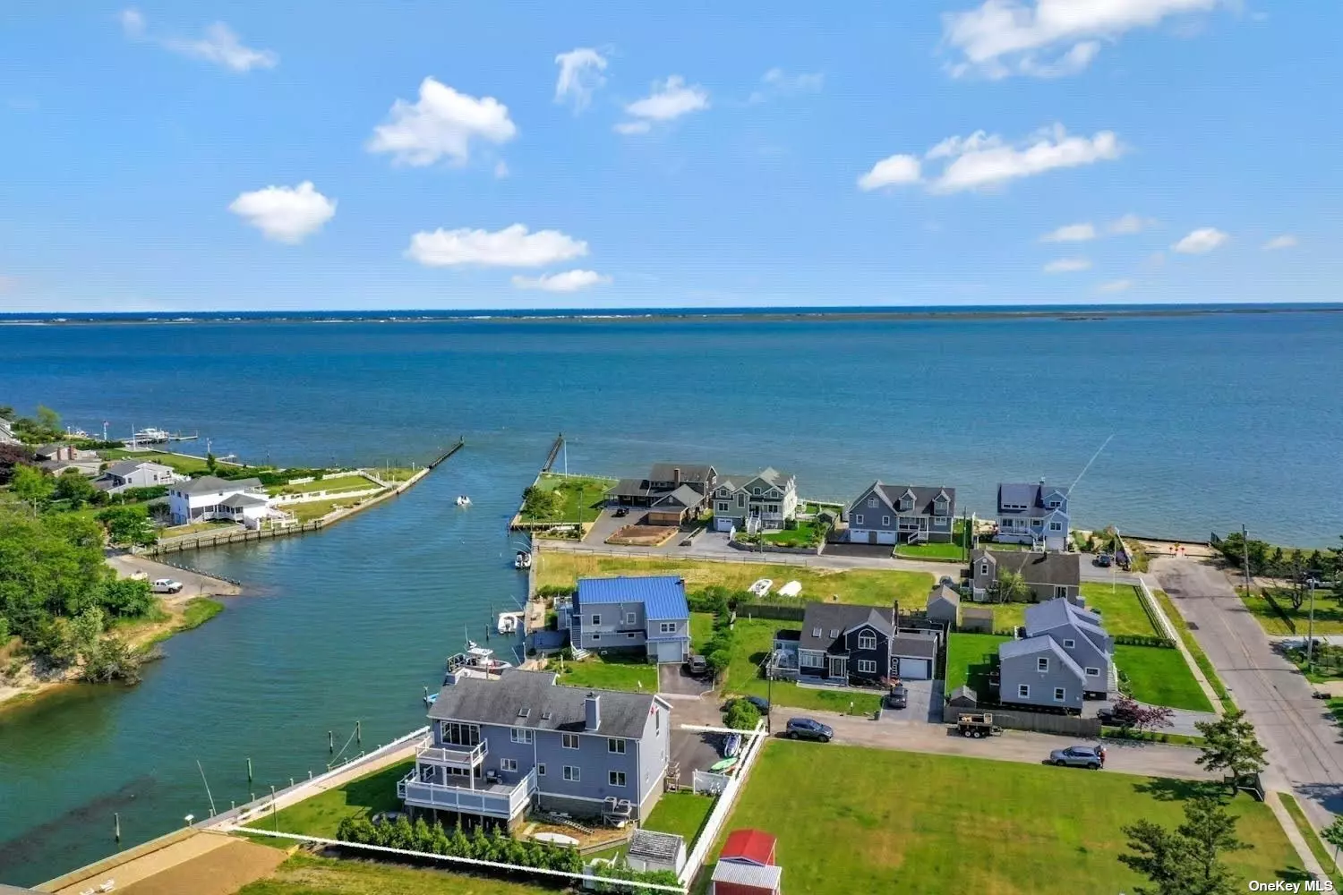 Waterfront Home with 107 ft Dock with Direct Access to Moriches Bay and Ocean. Deep Orchard Creek Canal With Endless Bay Views. Easy Access For Boating and Water Sport Enthusiasts. New Bulkhead (2021) This Home Was Lifted and Renovated in 2018. Features Harwood Flooring, Two Wood Burning Fireplaces, and Full Walk Out Basement .Large Driveway For Plenty of Parking. This Home Has So Much To Offer. Four Bedrooms With The Primary En Suite Offering Bucolic Views Of The Canal and Bay Each and Every Day. A True Respite With Wood Burning Fireplace For Total Ambiance. There Is Also An Open Loft Space For Quiet Moments. The Kitchen Offers Stainless Appliances As Well As Plenty Of Cabinetry and Counterspace. Sliders Overlooking A Large Mahogany Deck For Entertaining. Front Mahogany Decking. Front Paver Patio And Rear Paver Patio with Brick Firepit and Seating. This Home Is Perfect For Year Round Living Or A Summer Retreat For Family and Friends. Come See Your New Home.