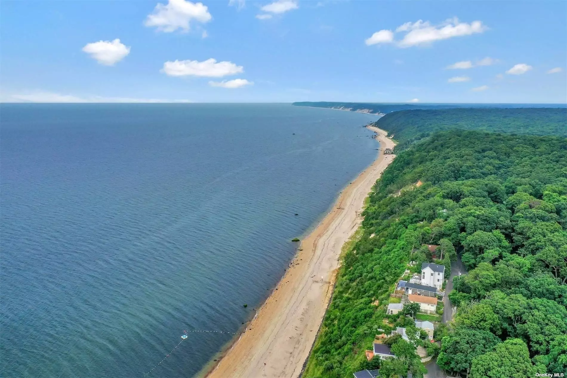 BEAUTIFUL WATERFRONT HOME! Totally renovated 2023. Community steps to private beach adjacent to home. New roof, heating system and central air systems installed 2017. New back yard retaining wall. Beautifully vegetated bluff with beach roses from the top to the beach offers security and stability for years to come. Beach level bulkhead rebuilt with stone toe armor added to prevent erosion.