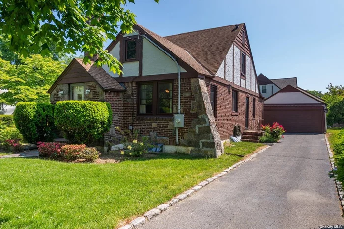 Welcome to this Tudor with gracious Architectural Detail, Elegant Stone Fireplace, Beamed Ceilings and a well-designed layout that effortlessly blends character and functionality. Formal Dining Room, Eat-In Kitchen, 4 bedrooms, 2 Full Baths, Full Basement, Lovely Property, 2 Car Garage, Large Attic & Storage. This residence exudes classic elegance and timeless appeal with newer custom windows that blend seamlessly into the interior and exterior decor. Close To Parks, Shops, Great Neck Park District Amenities.