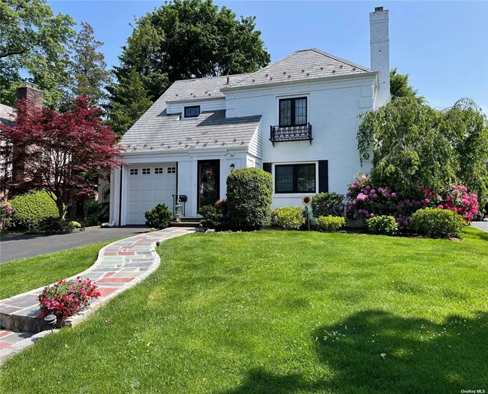 Bright, beautiful, and spacious describe this ideally located Colonial home, presenting the perfect balance of modern and traditional design elements. The crisp white-painted brick exterior is punctuated by sleek new black-framed Anderson windows. Large principal rooms include a gorgeous new white/grey-blue kitchen with quartz counters, island and walk-in pantry, and a sun-filled family room with oversized windows and a wall of functional built-ins. Additional features include a double-width driveway, large bedrooms, primary suite, oversized bluestone patio and a substantial yard surrounded by beautiful perennial gardens and mature perimeter landscaping, offering unusual privacy and great entertaining space. Wonderful mid-block location, close to town, train and secondary schools.