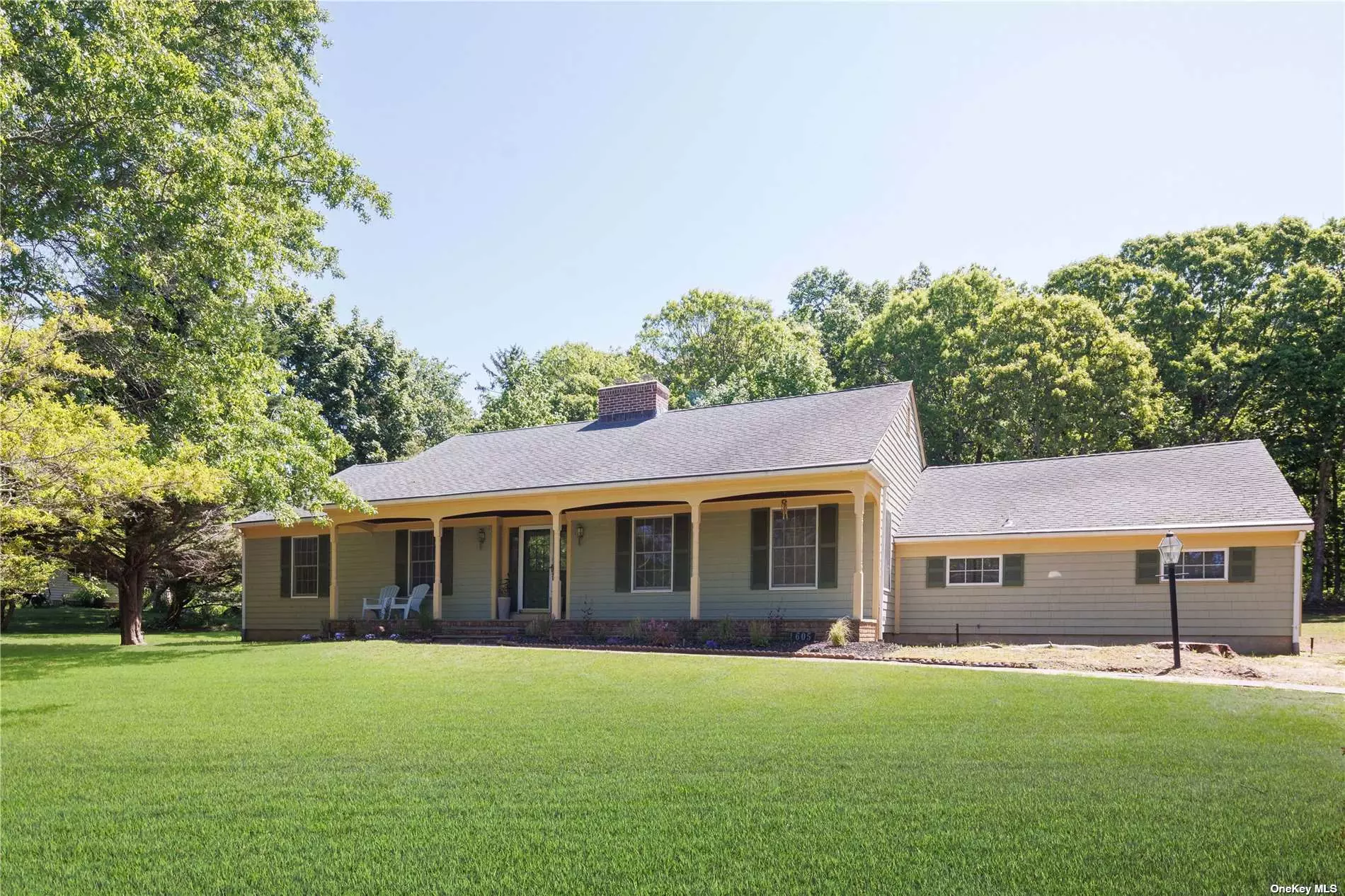 Stylish move-in ready ranch features updated kitchen and baths, refinished floors, and a cleared shy acre lot abutting preserved land. A brick wood-burning fireplace anchors the semi-open floor plan, with living space extending to a large four seasons sunroom. Primary bedroom suite plus two additional bedrooms and a full bath round out your interior finished space. Attached two-car garage, full basement, and plenty of room for a pool. Just over a mile to Cedar and Goose Creek beaches.