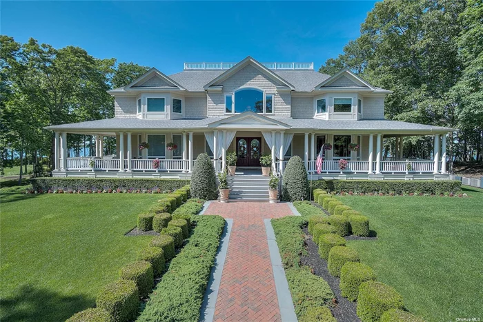 Discover the charm of waterfront living on this 8-acre estate along Southold Bay, boasting 157 feet of pristine shoreline and a private beach for tranquil retreats. The welcoming gates open to a driveway lined with pear trees, leading to a home that celebrates the beauty of its natural surroundings. The foyer unfolds into a living room illuminated by 24-foot windows, offering panoramic views of the bay and easy access to your secluded beach. The heart of the home, the kitchen, is ready for any culinary endeavor and seamlessly connects to the dining and living areas, ideal for casual entertaining. A guest suite on the ground floor provides a quiet escape for visitors. Upstairs holds four ensuite bedrooms, with two featuring balconies that invite the outside in, each morning graced by waterfront vistas. With over 6, 000 square feet, the home offers ample space while maintaining a cozy ambiance. Outdoor life is a breeze with a deck designed for relaxation and gatherings, against the backdrop of your own beachfront. Beyond the tranquility of your estate, downtown Southold beckons with its lively dining scene, shops, and wineries, blending coastal serenity with community vibrancy in this unique Southold bayfront home.