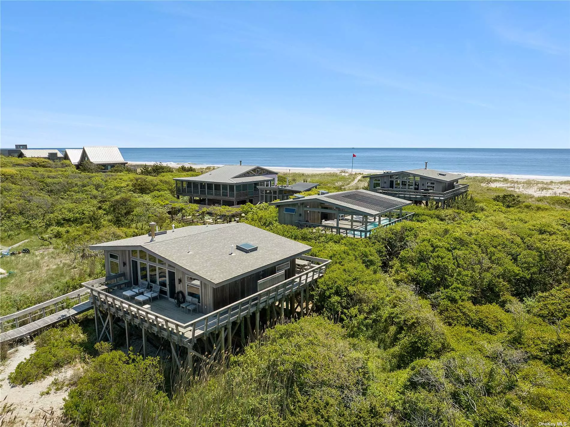 Welcome to One Atlantic Walk. This exceptional waterfront estate is located in the secluded Water Island community on Fire Island. The property transverses across a continuous .97-acre from the Great South Bay to the Atlantic Ocean and comprises 3 separate structures including The Ocean House, The Pool House, and The Bay House. From the moment you arrive at your private 250&rsquo; long dock in your 25&rsquo; Steiger Craft boat , which is included with the sale you are in true tranquil paradise. Your own private boardwalk leads you from the bay straight to the ocean. Totalling 4 Bdrms, 5 Full Bathrooms, Fitness Room and a Lap Pool, Atlantic Walk is the definition of a Secluded Beach Estate.