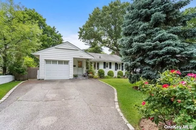 An updated and move-in ready ranch located in the desirable Terrace section of Port Washington. A cozy foyer leads you to the spacious and open L- shaped living room and dining room with skylight. The living room opens to a bright den area with its own skylight. The dining room leads to an updated kitchen with granite countertops and stainless-steel appliances with sunlight streaming through the skylight. The sliders in the back lead you to a beautiful, screened porch and patio where you can view and enjoy the lovingly planted garden with underground sprinkler system. At the other end of the house a hallway takes you to a large master bedroom which boasts of ample closet space. Two additional generous bedrooms and an updated full bath with travertine tiles and custom cabinets round out the living space. The full basement includes walk in closets and abundant space for storage, laundry and utilities. This house is close to the train, parks, marinas, shops and restaurants. Come and view. Too much to list!!