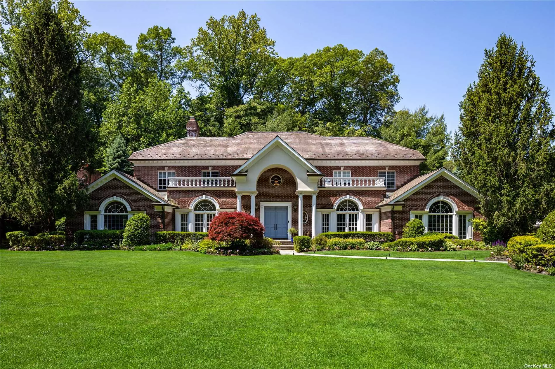 An Exceptionally Redesigned Center Hall Brick Colonial on 1.06 lush Acres in the sought-after Flower Hill Community of Manhasset, NY. Totaling roughly 6, 247 Sq.Ft. of Interior Living Space, this bright home boasts tall 11ft. ceilings, brand new hardwood floors, large entertaining areas including a Den with a Wet-Bar, great for hosting guests, and a Modern, Eat-In Kitchen with Marble Countertops, oversized Rose-Gold Hardware, beautiful Textured Wallpaper and Five-Star Wolf/ SubZero Appliances. Featuring a Master Suite Oasis, with multiple Walk-In Closets and a Spa-Like Bathroom with Radiant-Heat Stone Floors, a Steam Shower and a Stand-Alone Soaking Tub. Additional home details include 4 more Bedrooms and 3.55 Bathrooms, a Finished Basement with a Fitness Room, an Attached 3-Car Garage and a flat backyard with a large slate patio and matured privacy plantings. Architecturally pleasing, the home is outfitted with elegant crown moldings, thick-cut millwork, hallways adorned with curved ceilings, seamless built-ins and an abundance of natural light. Located on a private, cul-de-sac street, within the esteemed Manhasset Union Free School District.