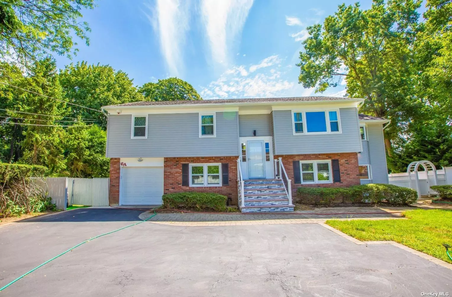 Welcome to a beautiful French Country brick home located in the Heart of Syosset, a few minutes to LIRR Station, and surrounded by restaurants and shops. This single family home (Mother-Daughter Style) has been renovated from top to bottom, including a newly marbled shower room and an open layout sunroom, incorporating Asian and French design details throughout the space. Each bed-rooms and living-rooms are furnished with a newly installed Mitsubishi split air conditioner as well. The main foyer features modern chandelier lighting and beautiful hardwood floors, leading to a large, naturally lit living room. Interior highlights include high ceilings and expansive, arched windows overlooking the chef&rsquo;s kitchen and the greenery outside. The chef&rsquo;s kitchen has a center island attached to a semi-automatic and vent. Along the kitchen walls are a large stainless steel kitchen sink, a spacious refrigerator, and a wine rack with built-in cooling. Elegant French doors lead you into a cozy office or playroom space, featuring skylights and a fireplace. The upper level in sum contains: 3 bedrooms, 1 full bath, a kitchen, a sunroom, and 2 living rooms. The lower level features 2 bedrooms, a full bath, a kitchen space, and 2 living rooms. Both bedrooms are sizable with built-in closets, and the full bath features double sinks and a marble top vanity. From the dining rooms, a sliding door leads you to a charming backyard. Outdoor highlights include a Japanese inspired garden design with Japanese benches, a lantern sculpture, and professionally landscaped green space. The large space and convenient access to excellent private and public schools nearby make this the perfect home for the families looking to move to Syosset.