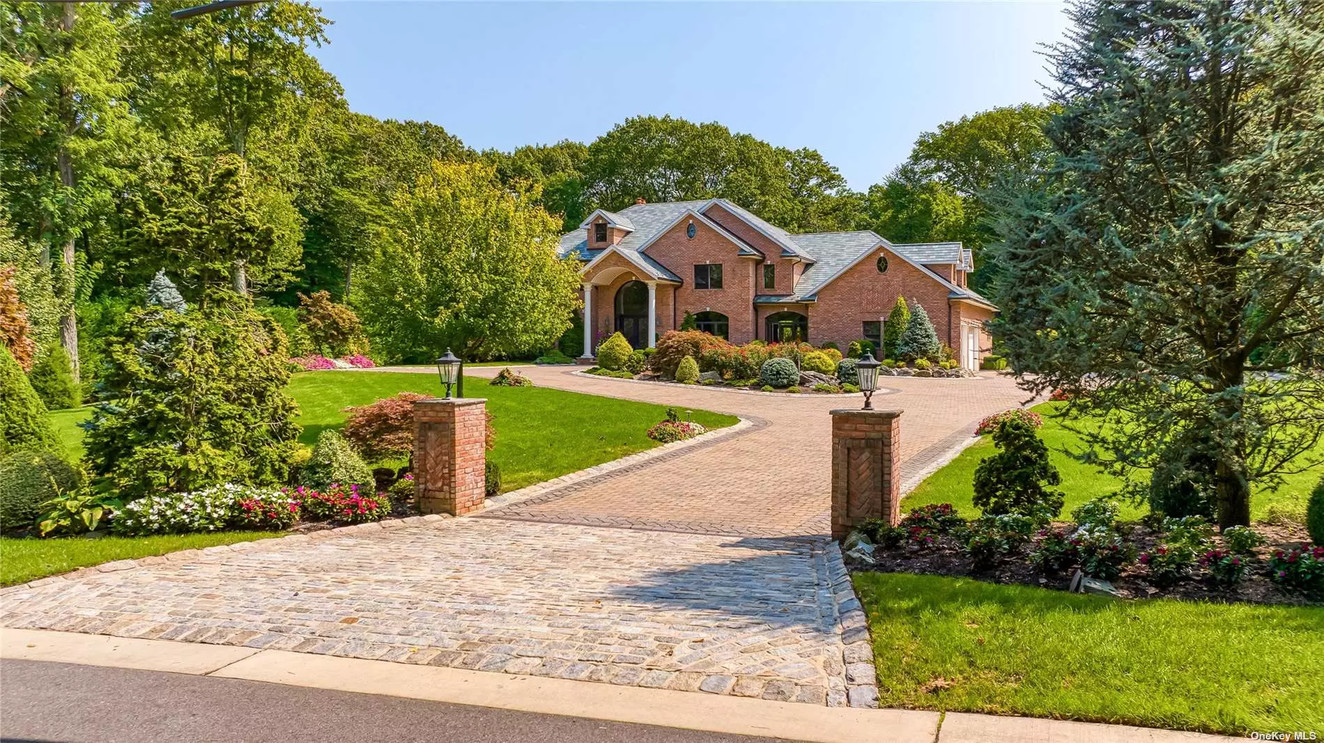 Grand 7091 square foot colonial set on 2 bucolic acres with inground heated salt water pool, waterfall and granite surround. This 2008 custom built brick home has a circular stone driveway, slate roof, breathtaking 2 story (20 foot) entry with 10 foot ceilings throughout the first floor and 9 foot ceilings on the second floor. There are floor to ceiling windows, custom cabinetry & mantle surround the den fireplace with stone reaching the 20 foot coffered ceiling. The den&rsquo;s open floor plan spans into the custom granite center island chef&rsquo;s kitchen with state of the art designer appliances. There is a banquet sized dining room, powder room, formal living room, main level office and bath, primary suite, plus guest bedroom & bath & laundry. Second floor has 2 ensuite bedrooms and 2 additional bedrooms with Jack and Jill bath. The basement has a double door outside entrance and full bath. Additional features incld, 3.5 car garage, generator, ugs, radiant heat and 400 amp