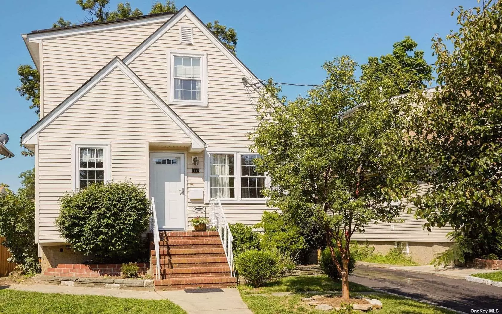 Expanded w/ energy efficient renovation, bright, sunny open floor plan. 4 Bedrooms , Eik/ Great room, Den, 2 Superior baths, 2 zone CAC, gas heat, owned solar panels ($10 /mo elec bill incl CAC). New construction thermopane windows, hardwood floors, custom woodwork, 2 car parking off street, deep fenced in back yard, walk out full basement. Quiet part of street, 2 blocks to town park, beach, pool and tennis.