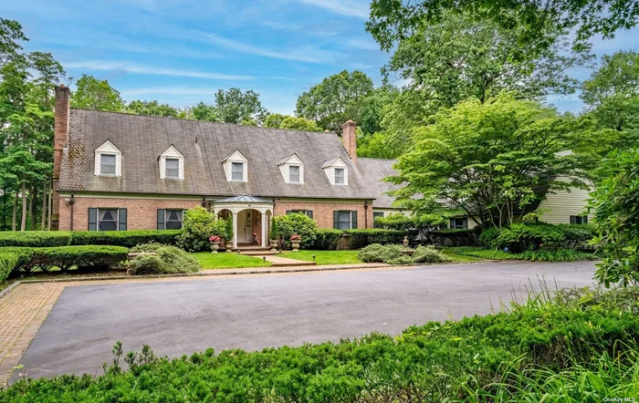 This Country Colonial is situated at the end of a scenic cul-de-sac. Highlights include a gated long drive detailed in Belgian block, 4.5 bathrooms, hardwood floors, and four fireplaces. Inviting large kitchen and den create a natural hub for the home. More formal entertaining can be enjoyed in the elegant living room and dining room. The sun room maximizes the use of light and space and offers a perfect setting to unwind and enjoy the view of the lush property. In addition there is a separate wing for long term guests. A verdant and lush property is surrounded by mature trees. Enjoy summer night around the sparkling in-ground pool. Gorgeous property for equestrians with horse trails near-by. Three-car garage, loft, barn and storage shed. Conveniently located near the famed Americana, the beach, golf and the Tilles Center for the performing arts. Jericho SD.