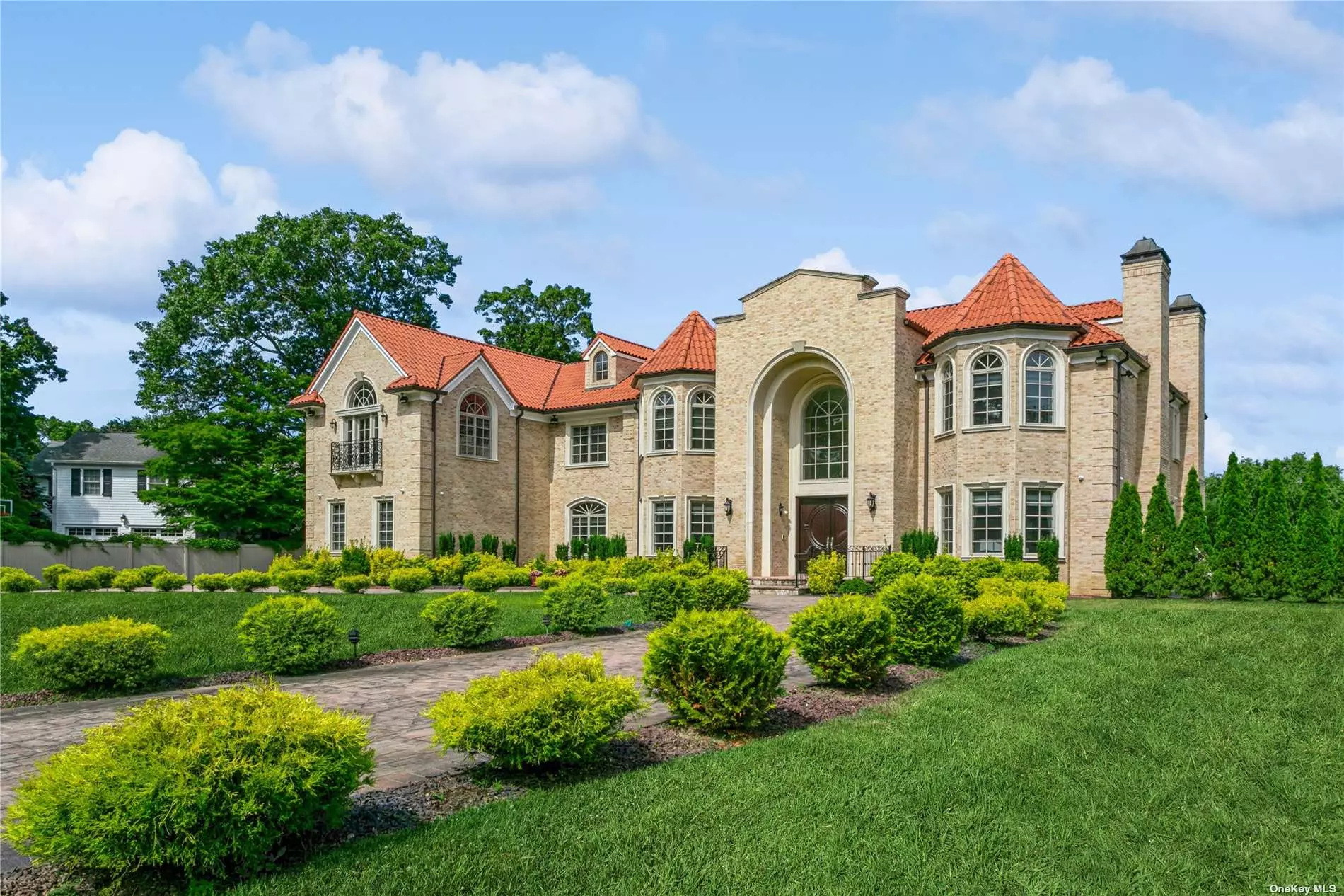 Experience the grandeur of this exquisite, newly constructed 11-bedroom contemporary colonial brick mansion totaling 14, 835 sq ft of living space in Back Lawrence, on a lot just shy of an acre. Every detail of this home showcases the highest level of craftsmanship and design. There are 13 radiant heat zones, 8 HVAC and full house generator. As you step inside, you are greeted by a breathtaking two-story center hall adorned with a dazzling Swarovski crystal chandelier. The main floor encompasses luxurious living room with fireplace, an elegant formal dining room, a stately family room with fireplace along with 3 Andersen doors leading onto a 1600 square foot patio, a formal library, plus an ensuite guest bedroom and a 3 car heated garage. Prepare to be amazed by a huge designer kitchen, featuring two stunning granite-topped islands, butler pantry, four top-of-the-line Wolf ovens, three sinks and two Miele dishwashers. With four Subzero refrigerators, this kitchen is equipped to meet the needs of even the most discerning professional chef. Ascend the grand staircase to the second floor, where six spacious bedrooms await, boasting high ceilings and impressive architectural details. Your own private oasis awaits in the master bedroom, complete with a generous sitting area, 4 walk-in closets, and a magnificent bathroom with modern Bain Ultra Whirlpool. An elevator services all the floors. The lower level of this masterpiece home offers a pleasant surprise with its nine-foot ceilings. A custom-built walnut bar takes center stage in an expansive and elegant entertainment area with a theater, billiard room and gym, perfect for hosting memorable gatherings. Let this be the home of your dreams, where you can create beautiful and lasting family memories! Close to many houses of worship!