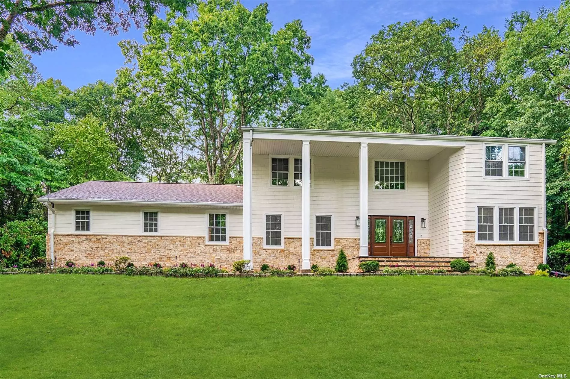 Fully Renovated in 2023! Welcome to your dream center-hall colonial nestled on 1 acre in the desirable Hunting Hill section of Woodbury, in Syosset School District. With meticulous attention to detail and quality finishes, this home boasts five bedrooms and three and a half bathrooms, all expertly renovated in 2023. The main level features an open concept floorplan, with a flow perfect for entertaining. Boasting a spacious gourmet chef&rsquo;s kitchen with top-of-the-line Thermador stainless steel appliances, a wine cooler, quartz countertops and gleaming 5 white oak hardwoods throughout. Convenience meets luxury with a first floor ensuite bedroom, perfect for accommodating guests or serving as a private retreat. Also featuring a large formal living room, a powder room and cozy den with a wood-burning fireplace and French doors leading to the beautiful backyard. Upstairs, you&rsquo;ll discover a sanctuary in the form of a large primary ensuite with vaulted ceilings and a custom walk-in closet. Indulge in the fully renovated bathroom, complete with a soaking tub, a walk-in shower, a built-in vanity, and radiant floor heating. Three additional generously sized bedrooms offer ample space for relaxation and personalization. This gorgeous home is a testament to luxury and refinement. From the gourmet kitchen to the lavish primary ensuite, every detail has been carefully curated to create a truly exceptional living experience. Features also include; 3 car attached garage entering into the home, first floor laundry and mudroom, full basement with brand new energy star mechanicals, heated driveway, brand new central vacuum, Kohler Fixtures, new HVAC & more! (Photos have been digitally staged)