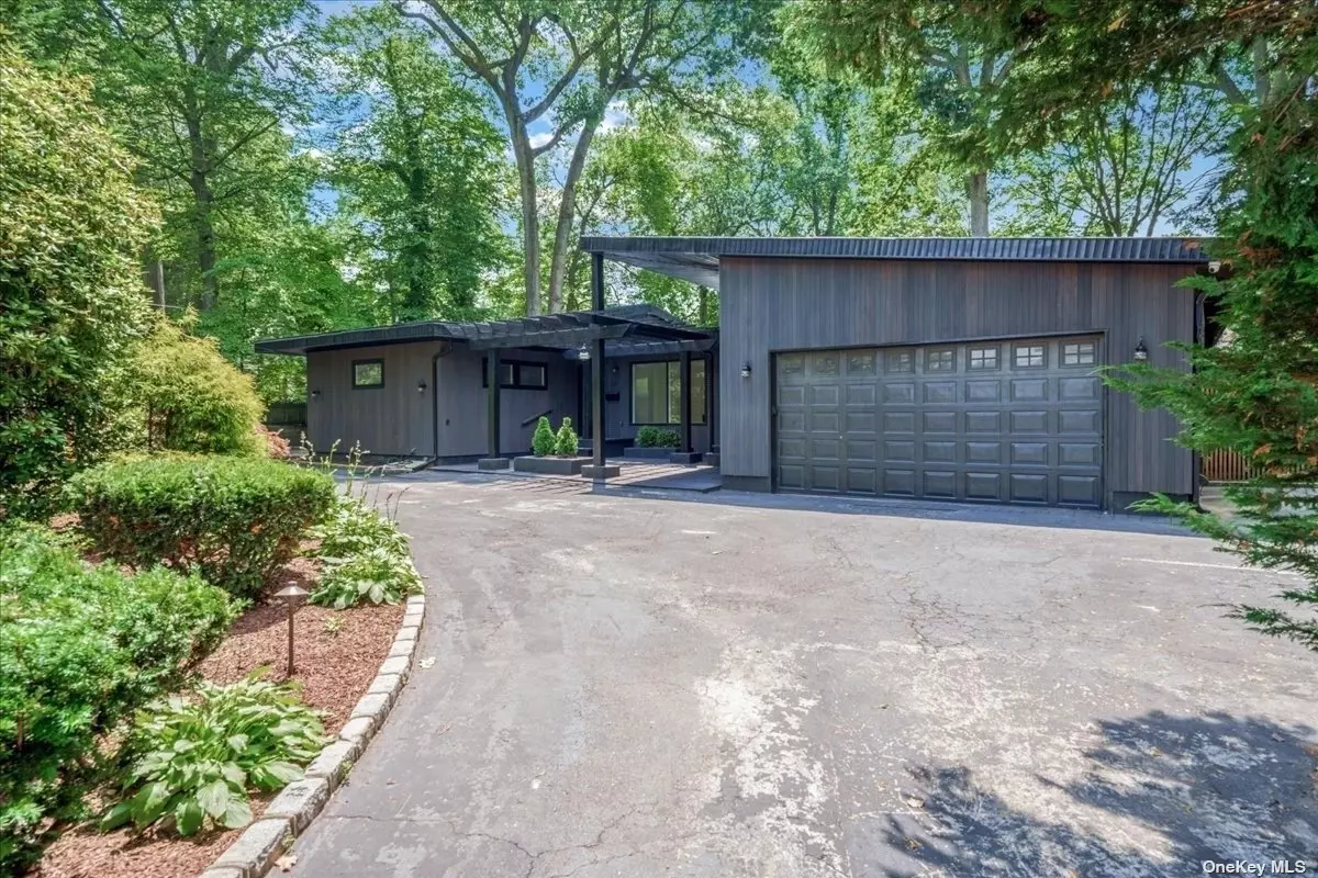 Welcome to this beautifully renovated and rare expanded ranch with impeccable curb appeal sitting on over half an acre in Glen Cove. Stepping inside, you&rsquo;ll immediately notice the an expansive and light-filled interior and beautiful custom herringbone laid hardwood oak flooring. Everything in this home is newly renovated and absolutely stunning. The kitchen features top-of-the-line appliances, custom cabinetry, a custom marble sink, and marble countertops. Marble shelves and marble walls were installed along the sides with along with a center island which is perfectly placed for casual meals and get togethers. The pantry is outfitted with double doors and is custom built with tons of storage. The living room is the showstopper of the home boasting cathedral style high ceilings and is surrounded by large windows fills the room with natural light. The primary suite is oversized with vaulted ceilings. It is fully loaded with a custom built walk in closet, and an en-suite marble bathroom with custom flooring. This spa-like oasis features a floating soaking tub, custom marble double vanity built with a single marble slab, a double showerhead walk-in shower, and custom cabinetry. Their secondary suite is also ample in size and features a new bathroom with glass tiles, a walk in shower, and a stone sink. The closet has also been built out. The additional two bedrooms are near equal in size-both feature closets. Across from the two bedrooms you&rsquo;ll a find the third bathroom, which features vaulted ceilings with a skylight and is finished in a special painted cement walls. The home is outfitted with a brand new washer dryer with a special filtrated water system that allows you to wash without detergent. The internet system is newly installed allowing two access points and one wifi extender to reach anywhere within the property. The home is outfitted an extensive eight camera security system Brand new central air conditioning and boiler-which was converted to gas. No detail has been spared on this home. The entire house is made with mahogany wood. Window moldings, roof trims, pergula all painted black. The entire entrance was redone with custom pavers. The backyard has custom lighting installed around the tree line. The homeowner has paid for outdoor plans for a deck, pool, firepit, and landscaping that will be included.