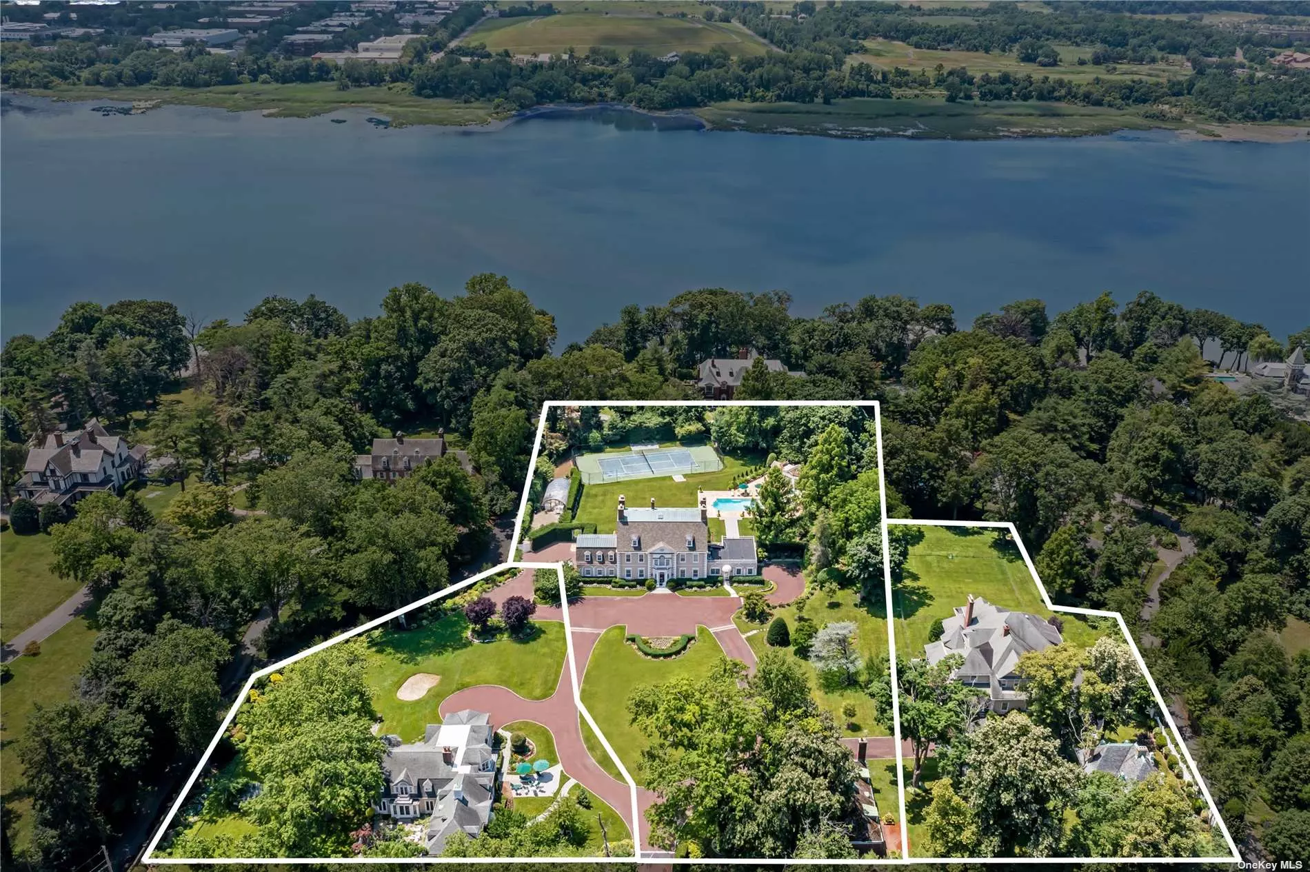 Want to live in a home as rich in history as it is beautiful? This gorgeous compound on the North Shore of Long Island has it all. This one in a million property, which has been under the same ownership for 50 years, boasts 3 separate homes, a coach house and a gate house, a pool and a tennis court, all enclosed by a privacy wall and an electric gate. Once inside, the property feels like an oasis. The 7, 500 Sq.Ft. Main Residence encompasses 9 bedrooms, 7.5 bathrooms and exudes elegance from every detail of the home. House #2 is a beautiful 6-bedroom Colonial featuring hardwood floors, a stately step-down living room/ dining room combination with mirroring fireplaces and a large Primary Suite with dual walk-in-closets. Completed in 2003, House #3 is a 6 bedroom, 6, 400 Sq.Ft. Colonial with tall ceilings, an oversized eat-in-kitchen that opens up to a spacious entertainment room with French doors leading out to a covered patio, allowing for effortless living and flow. All completed homes have full-house generators, attached garages and full/ finished basements. The two other buildings include The Coach House and The Gate House, which was constructed by Frederick Law Olmsted, the lead landscape architect for Central Park in Manhattan. Situated in an incredible location, the compound is only 26-miles from Manhattan, and enjoys winter water views. This unparalleled home is perfectly positioned between the Long Island Sound and the heart of The Village of Roslyn, with close proximity to the best of the North Shore including luxe shopping, high-end eateries and world-renowned golf courses such as Engineers Country Club and North Shore Golf Club.